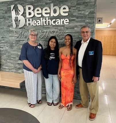 Gathered for the Lord Baltimore Lions Club scholarship presentation are (l-r) Tracy Bell, Margaret H. Rollins School of Nursing at Beebe Healthcare program coordinator; recipients Lillie Golub of Millsboro and Jamesia Alphonse of Delmar; and Anthony Rinaudo, Lord Baltimore Lions Club scholarship chair.